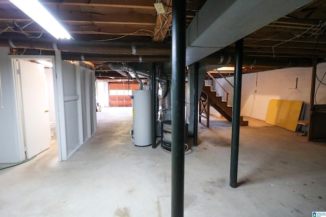 below grade area with stairway, heating unit, and gas water heater
