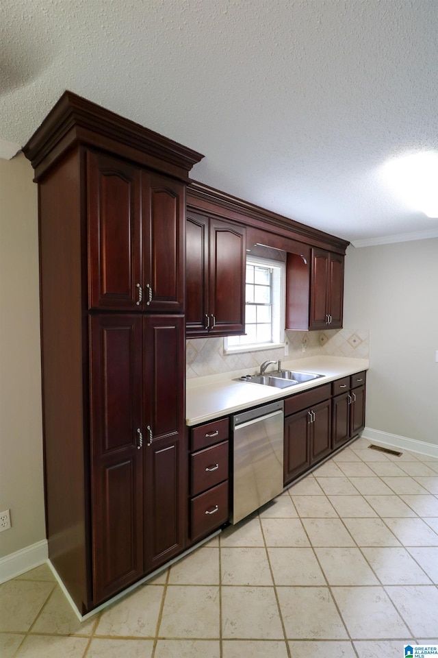 kitchen featuring decorative backsplash, light countertops, a textured ceiling, a sink, and dishwasher