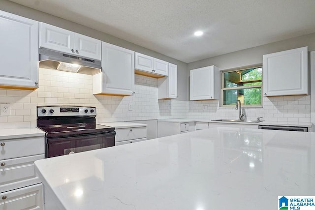 kitchen featuring under cabinet range hood, white cabinetry, a sink, and range with electric cooktop