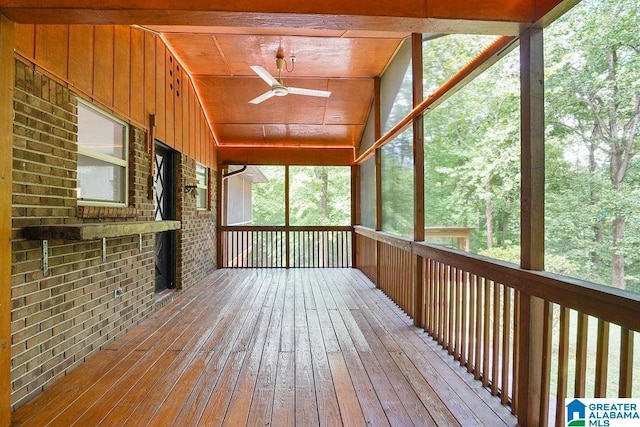 unfurnished sunroom with a ceiling fan