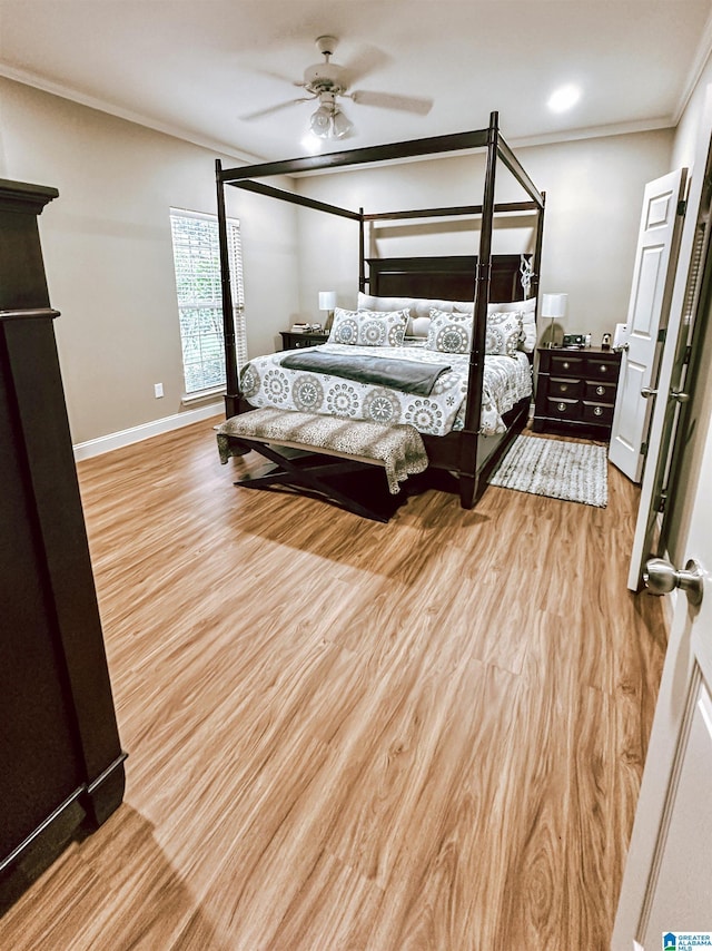 bedroom with crown molding, wood finished floors, baseboards, and ceiling fan