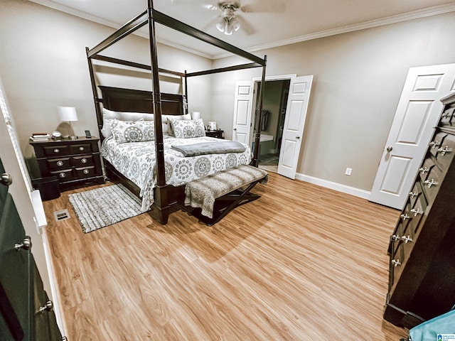 bedroom featuring wood finished floors, baseboards, and ornamental molding