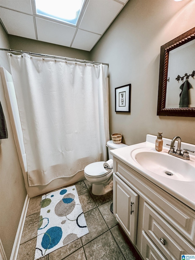 bathroom featuring toilet, vanity, tile patterned floors, and shower / bath combo