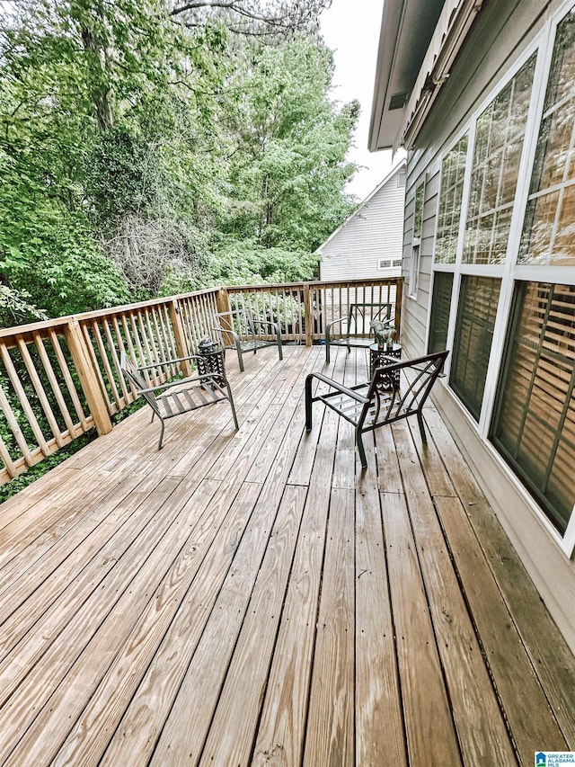 wooden terrace with outdoor dining area