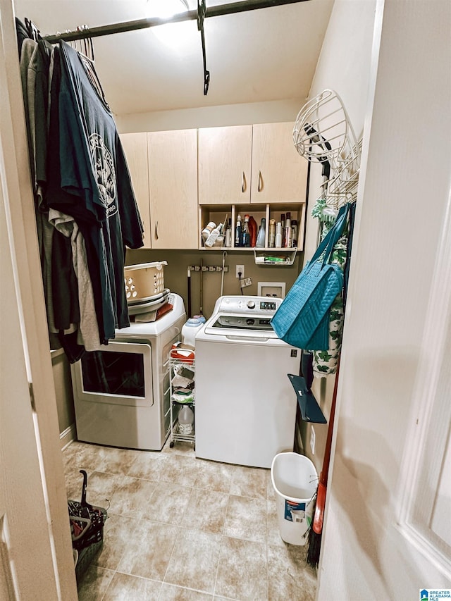 laundry room featuring washing machine and dryer and cabinet space