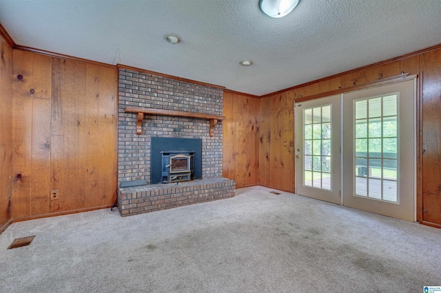 105 Campbell Rd, Clanton, AL 35045 - unfurnished living room featuring wooden walls, carpet flooring, and a textured ceiling