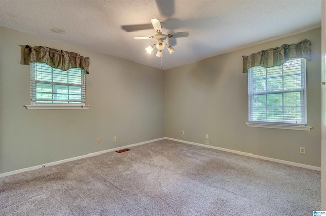 105 Campbell Rd, Clanton, AL 35045 - carpeted spare room featuring baseboards, a healthy amount of sunlight, ceiling fan, and visible vents