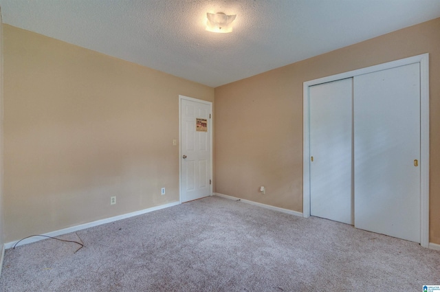 105 Campbell Rd, Clanton, AL 35045 - unfurnished bedroom with a textured ceiling, carpet, baseboards, and a closet