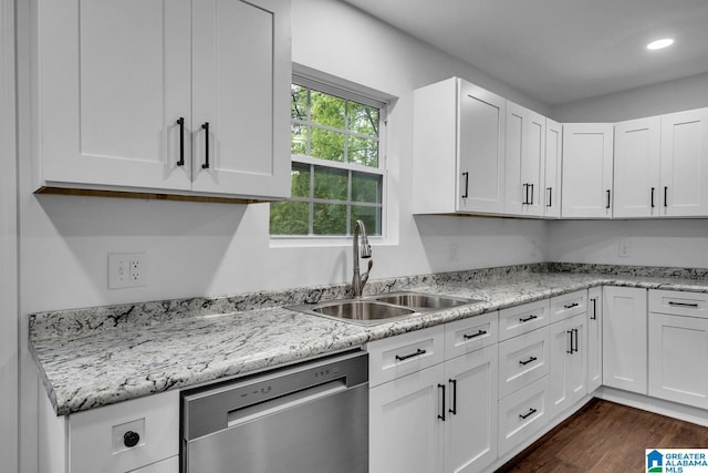 kitchen featuring stainless steel dishwasher, a sink, dark wood finished floors, and white cabinets