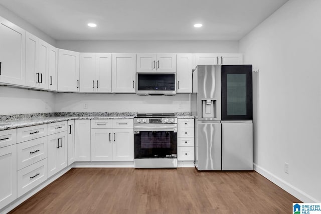 kitchen featuring stainless steel appliances, baseboards, recessed lighting, white cabinetry, and dark wood-style floors