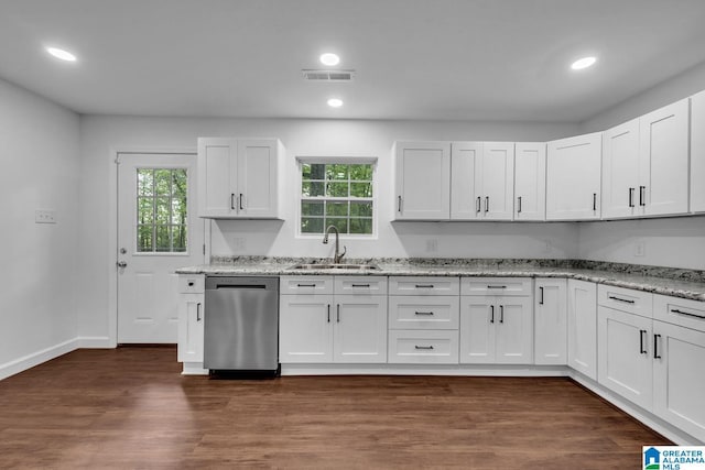 kitchen with light stone counters, visible vents, a healthy amount of sunlight, and dishwasher