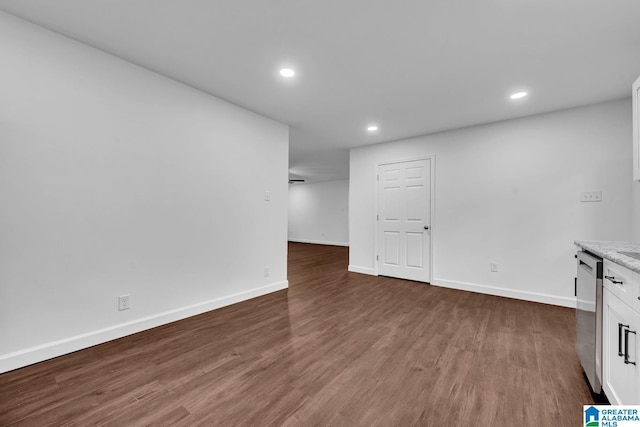unfurnished living room with baseboards, recessed lighting, and wood finished floors