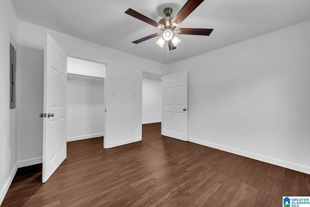 unfurnished bedroom featuring dark wood-type flooring, baseboards, ceiling fan, and a closet
