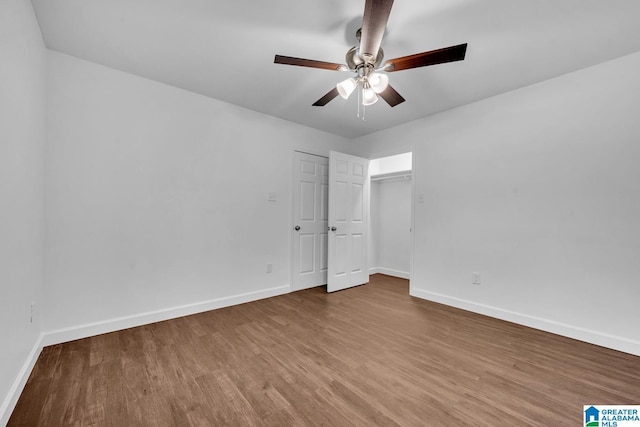 unfurnished bedroom featuring baseboards, ceiling fan, and wood finished floors