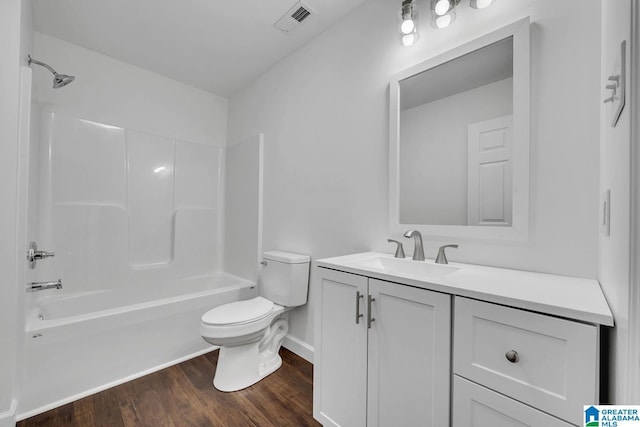 bathroom featuring vanity, toilet, shower / bath combination, wood finished floors, and visible vents