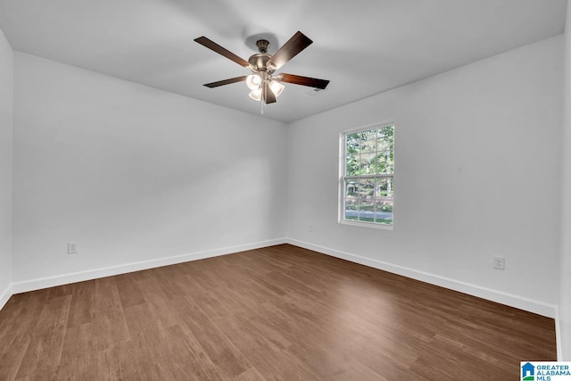 unfurnished room featuring baseboards, a ceiling fan, and wood finished floors