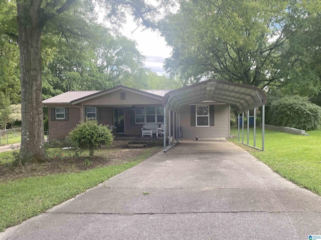ranch-style home with a carport, a front lawn, metal roof, and concrete driveway