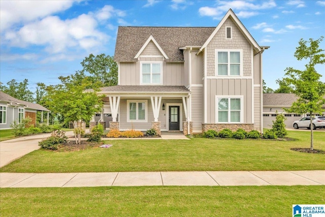 4546 Brexton St, Trussville, AL 35173 - craftsman house with board and batten siding, a porch, a front yard, a shingled roof, and stone siding