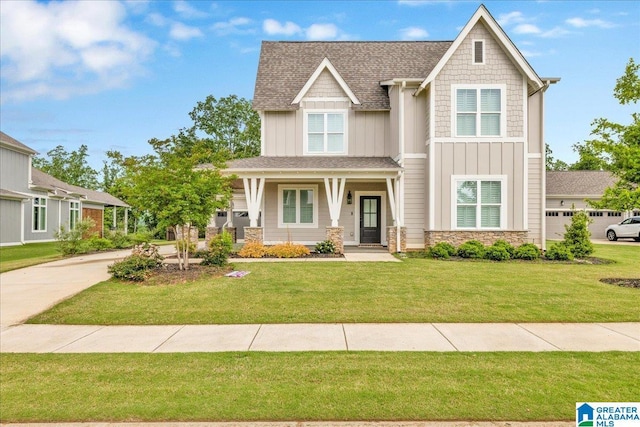 4546 Brexton St, Trussville, AL 35173 - craftsman-style home with board and batten siding, roof with shingles, a front yard, and stone siding