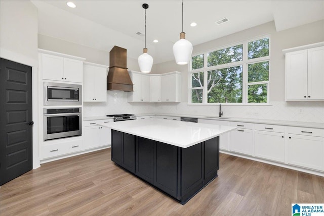 4546 Brexton St, Trussville, AL 35173 - kitchen featuring appliances with stainless steel finishes, a sink, light countertops, white cabinets, and custom exhaust hood