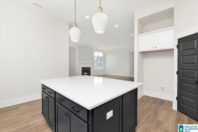 4546 Brexton St, Trussville, AL 35173 - kitchen with baseboards, white cabinets, light wood-type flooring, and visible vents