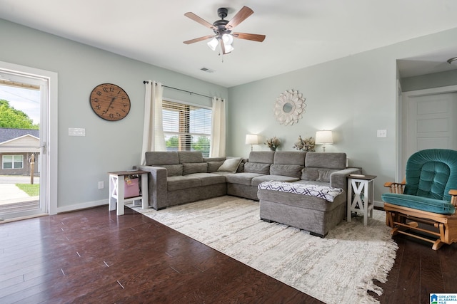 living room with baseboards, ceiling fan, visible vents, and wood finished floors