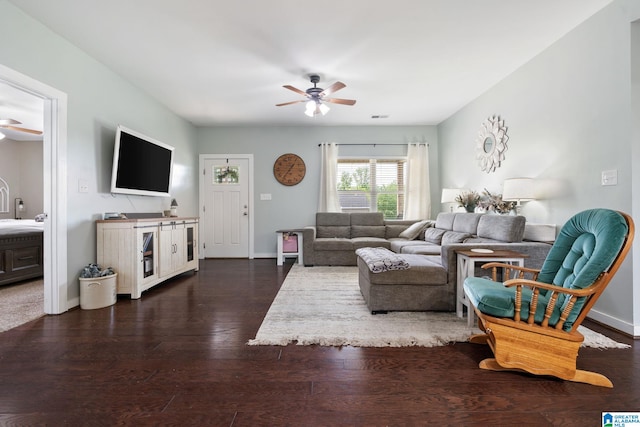 living area with dark wood-style flooring, a ceiling fan, baseboards, and visible vents