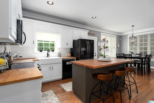 605 N Grande View Cir, Maylene, AL 35114 - kitchen featuring butcher block counters, black appliances, white cabinets, a kitchen bar, and backsplash