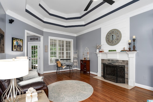 605 N Grande View Cir, Maylene, AL 35114 - living room featuring wood finished floors, a ceiling fan, a raised ceiling, ornamental molding, and a high end fireplace
