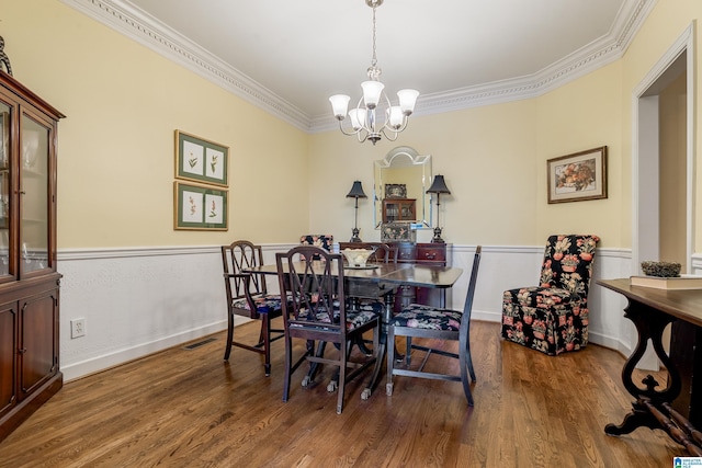 934 Chestnut Oaks Cir, Hoover, AL 35244 - dining room featuring ornamental molding, a chandelier, wood finished floors, and a wainscoted wall