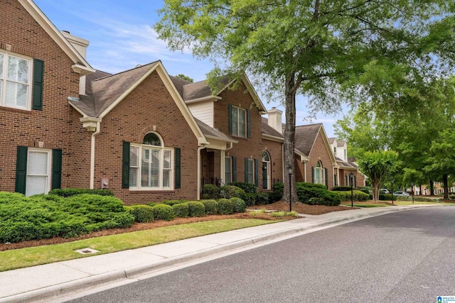 934 Chestnut Oaks Cir, Hoover, AL 35244 - view of front facade with brick siding, a residential view, and roof with shingles