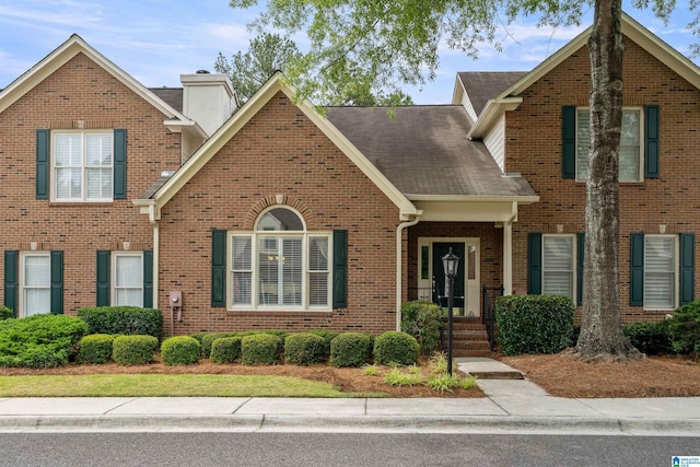 934 Chestnut Oaks Cir, Hoover, AL 35244 - traditional-style house with brick siding, a chimney, and a shingled roof
