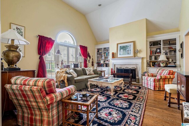 934 Chestnut Oaks Cir, Hoover, AL 35244 - living area featuring high vaulted ceiling, wood finished floors, a brick fireplace, and built in features
