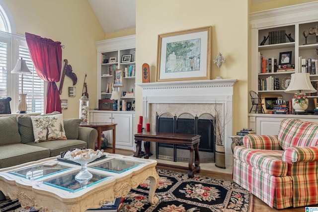 934 Chestnut Oaks Cir, Hoover, AL 35244 - living area with a premium fireplace, lofted ceiling, built in features, and wood finished floors