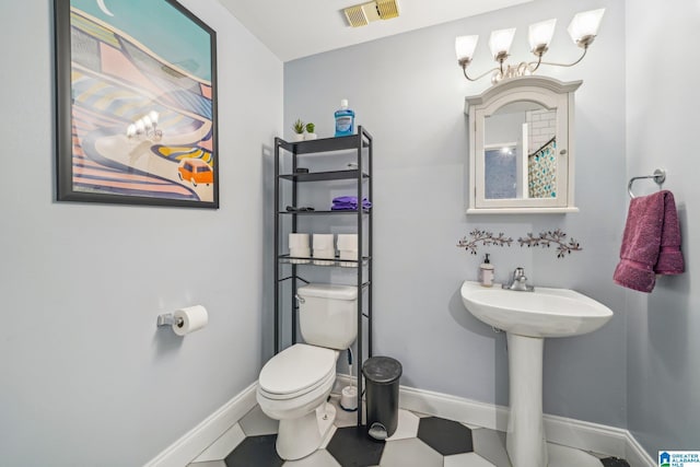 bathroom featuring baseboards and toilet
