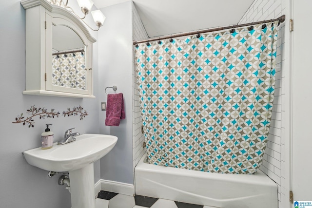 full bathroom with baseboards and shower / bath combination with curtain