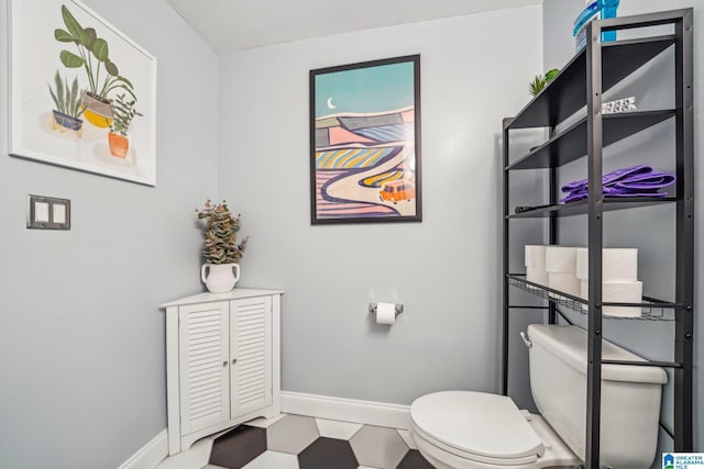 bathroom featuring baseboards, toilet, and tile patterned floors