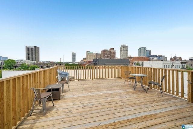 wooden terrace featuring a skyline view