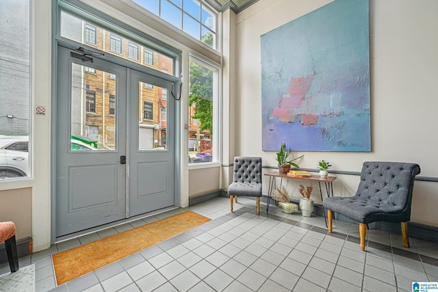 tiled foyer featuring baseboards