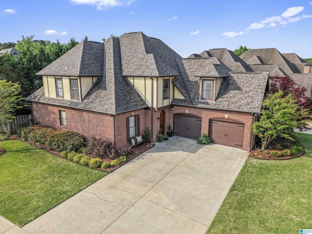 2608 Arbor Way, Hoover, AL 35244 - english style home featuring concrete driveway, brick siding, stucco siding, and an attached garage