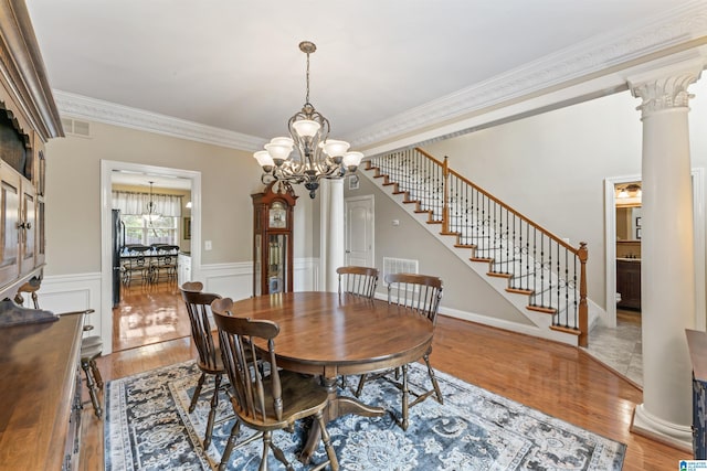 2608 Arbor Way, Hoover, AL 35244 - dining space featuring a chandelier, ornamental molding, stairs, wood finished floors, and wainscoting
