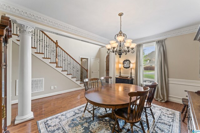 2608 Arbor Way, Hoover, AL 35244 - dining area featuring ornamental molding, decorative columns, wood finished floors, stairs, and baseboards