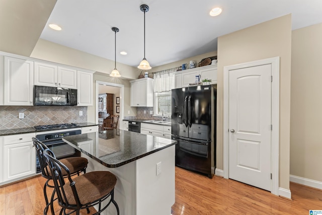 2608 Arbor Way, Hoover, AL 35244 - kitchen with black appliances, a sink, white cabinets, light wood-style flooring, and recessed lighting