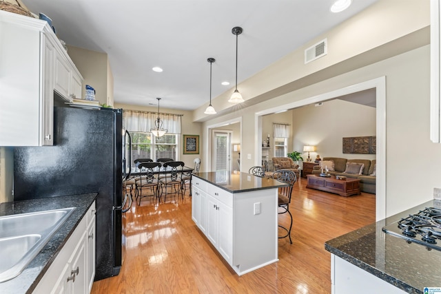 2608 Arbor Way, Hoover, AL 35244 - kitchen featuring light wood finished floors, a sink, white cabinets, a kitchen breakfast bar, and recessed lighting