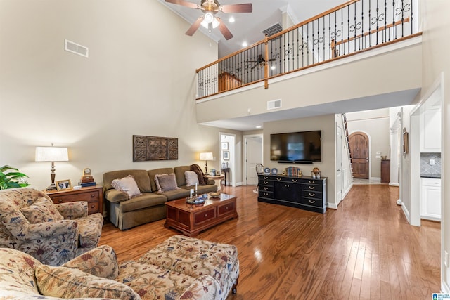 2608 Arbor Way, Hoover, AL 35244 - living area with a high ceiling, ceiling fan, light wood-style floors, arched walkways, and baseboards