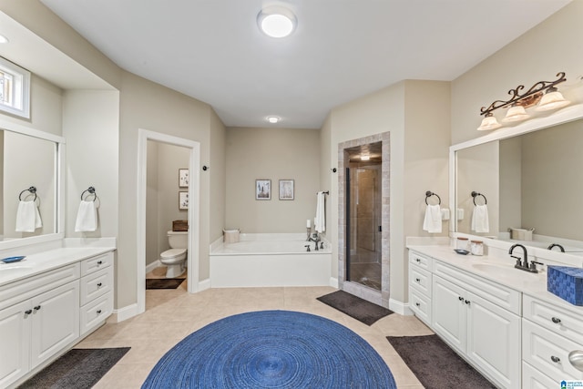 2608 Arbor Way, Hoover, AL 35244 - bathroom featuring a stall shower, tile patterned flooring, two vanities, toilet, and a garden tub