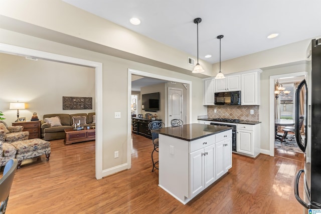 2608 Arbor Way, Hoover, AL 35244 - kitchen featuring black appliances, light wood finished floors, white cabinetry, dark countertops, and decorative backsplash
