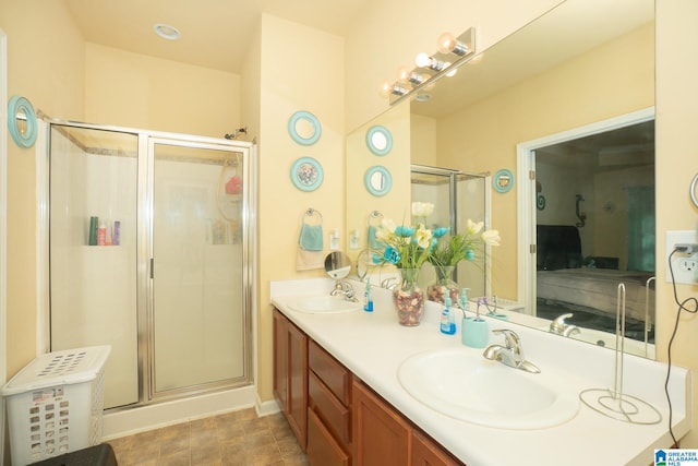 ensuite bathroom featuring a sink, double vanity, ensuite bathroom, and a stall shower