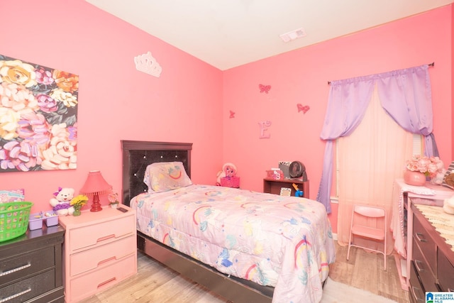 bedroom featuring light wood-type flooring and visible vents