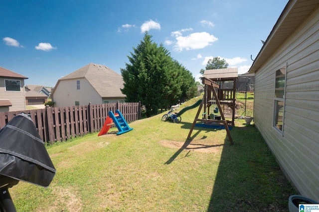 view of yard featuring a playground and fence